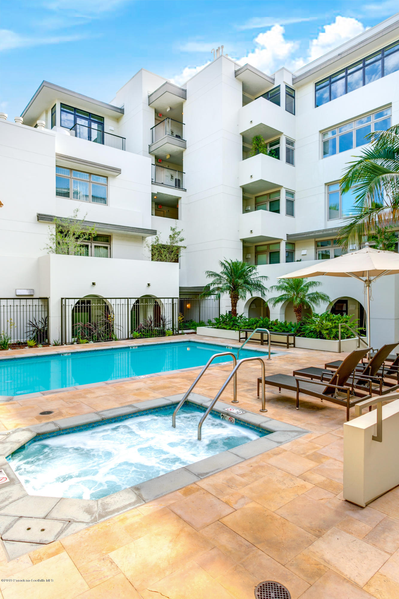 920 Granite Drive, Unit 309 Pasadena, CA 91101 - Photo 35 of 40 a view of a swimming pool with lawn chairs and plants