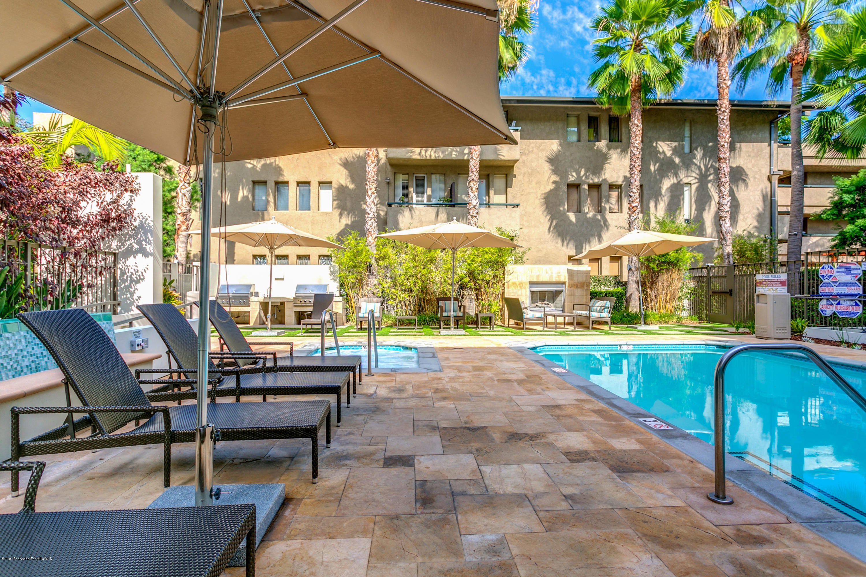 920 Granite Drive, Unit 309 Pasadena, CA 91101 - Photo 38 of 40 a view of a patio with a table and chairs under an umbrella