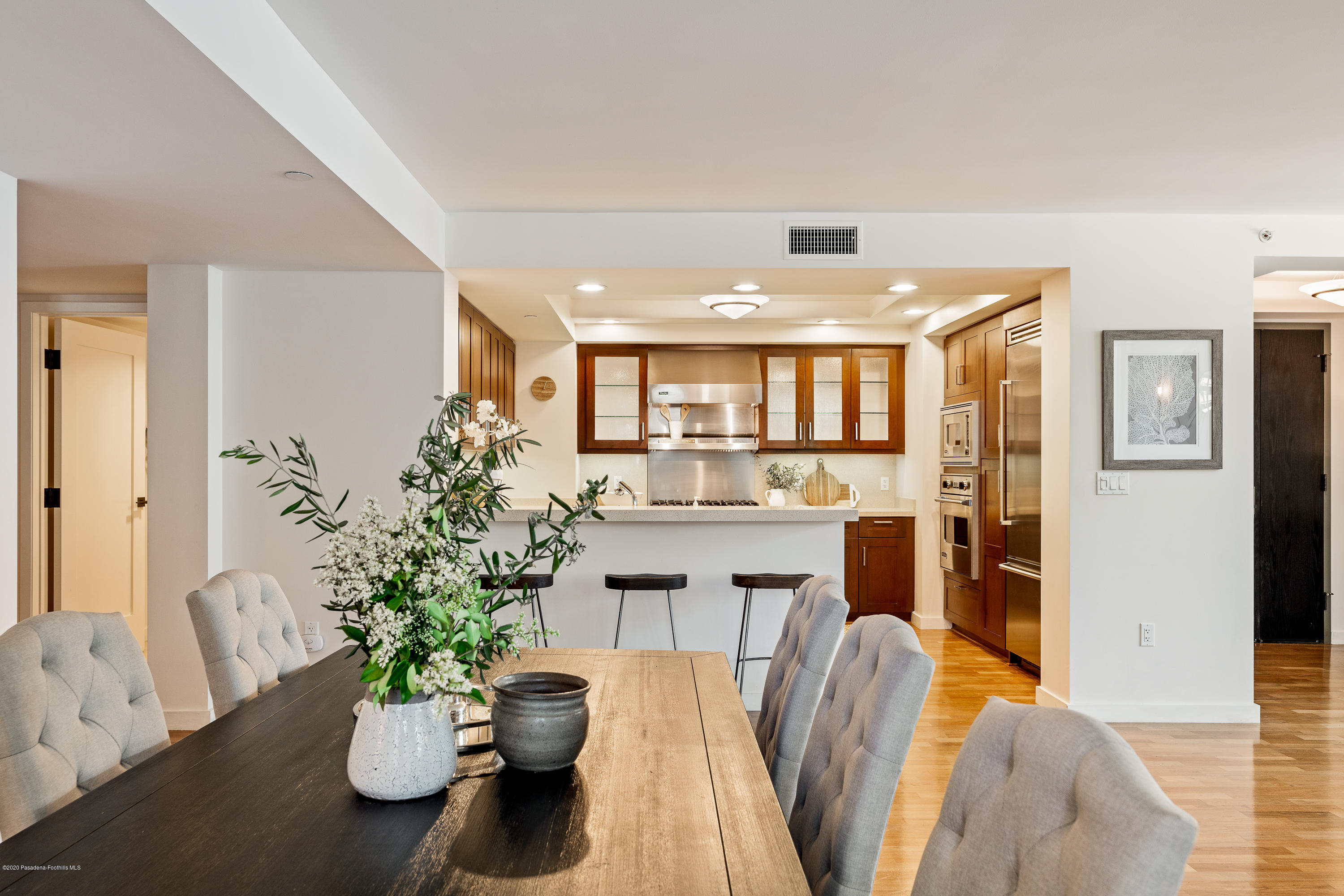 920 Granite Drive, Unit 309 Pasadena, CA 91101 - Photo 9 of 40 a dining room with furniture and a chandelier