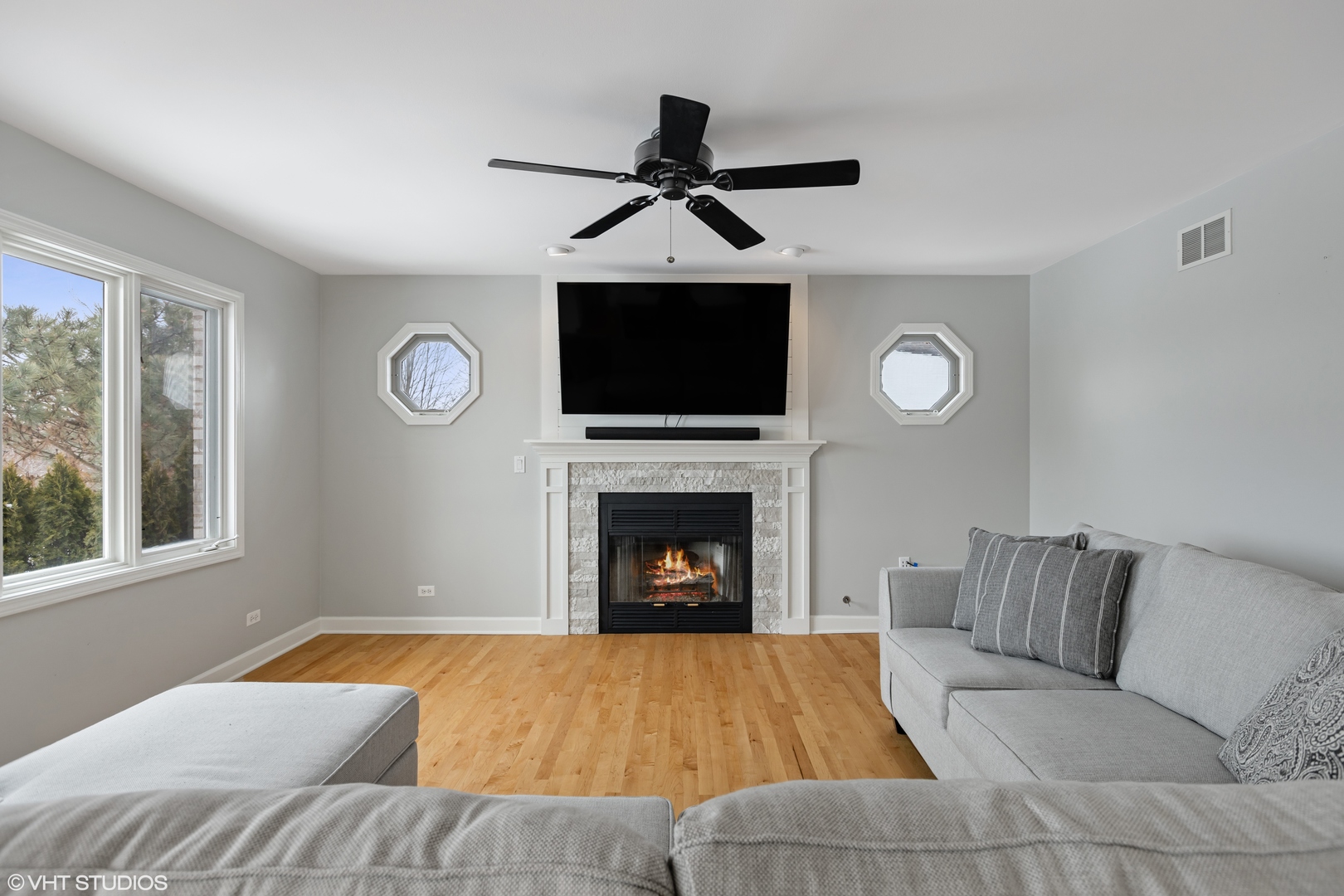 1909 Cornell Drive New Lenox, IL 60451 - Photo 11 of 26 a living room with a fireplace furniture a flat screen tv and a fireplace