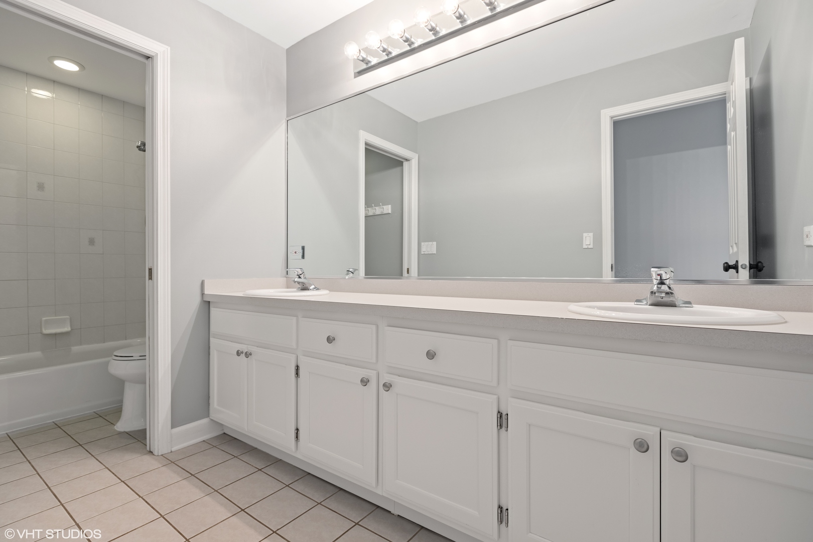 1909 Cornell Drive New Lenox, IL 60451 - Photo 19 of 26 a bathroom with a double vanity sink mirror and a bathtub