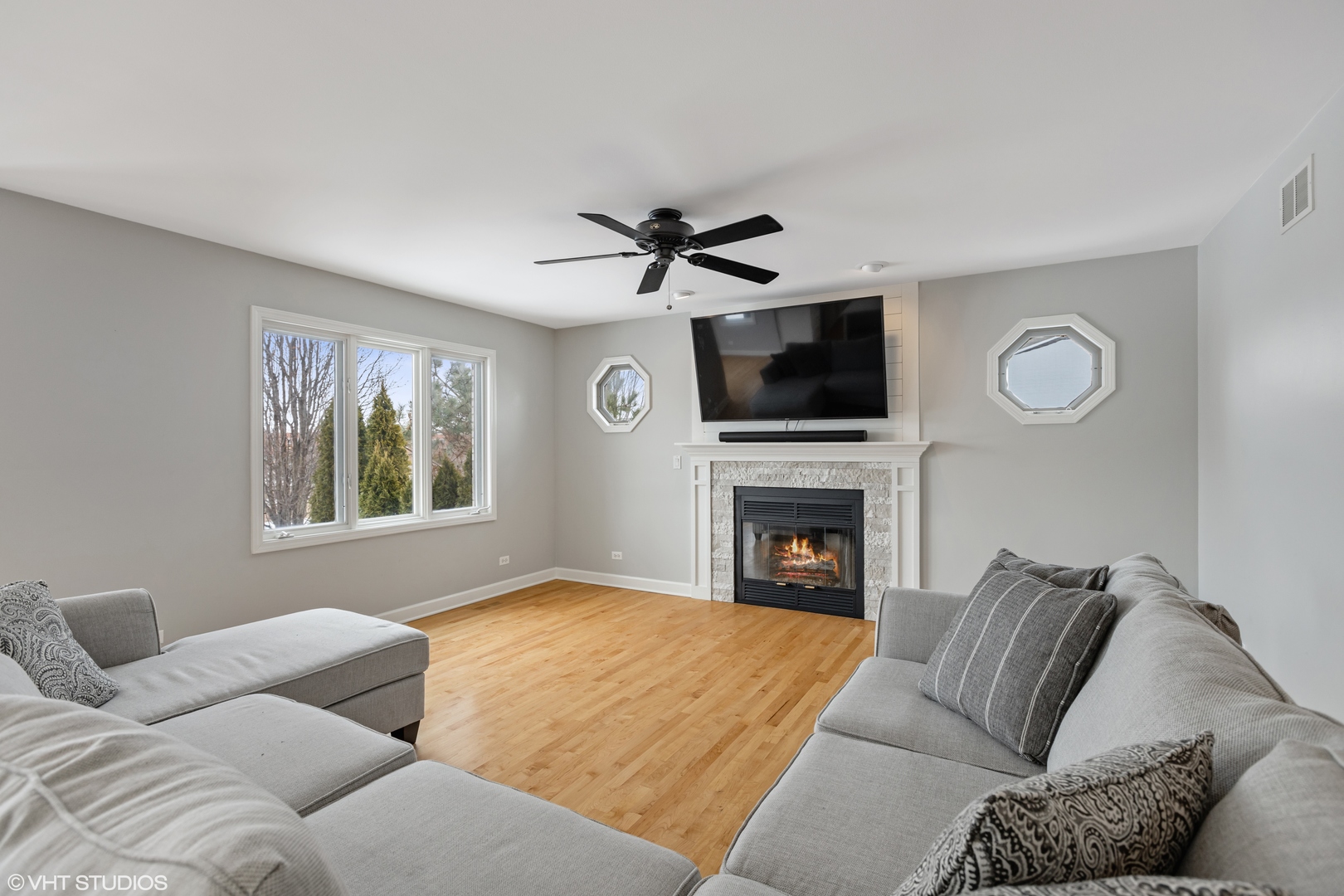 1909 Cornell Drive New Lenox, IL 60451 - Photo 10 of 26 a living room with furniture a fireplace and a flat screen tv