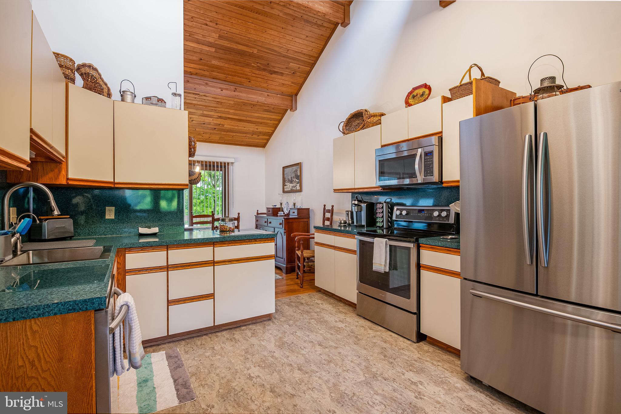 40 Golfview Lane Reading, PA 19606 - Photo 17 of 48 a kitchen with stainless steel appliances granite countertop a refrigerator a stove and a sink with wooden floor