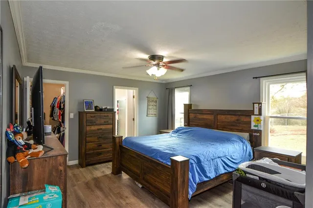 a bedroom with a bed and a chandelier