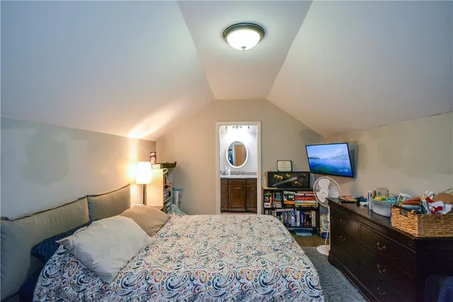 a bed room with a bed and a television