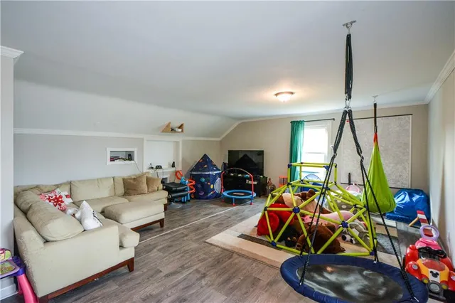 a living room with furniture a air conditioner and a window