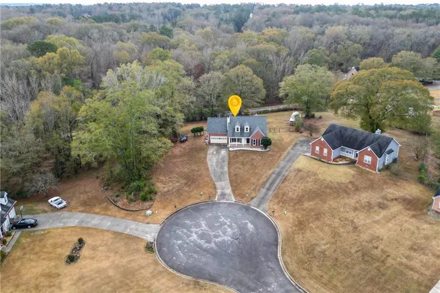 an aerial view of a house with outdoor space