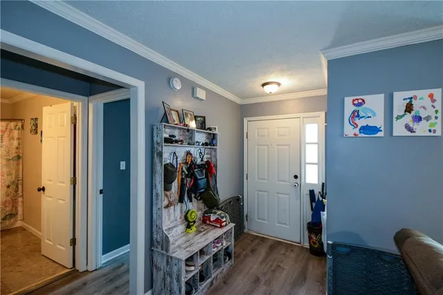 a view of an entryway with wooden floor