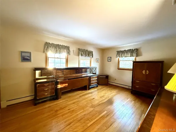 a view of workspace with wooden floor and furniture