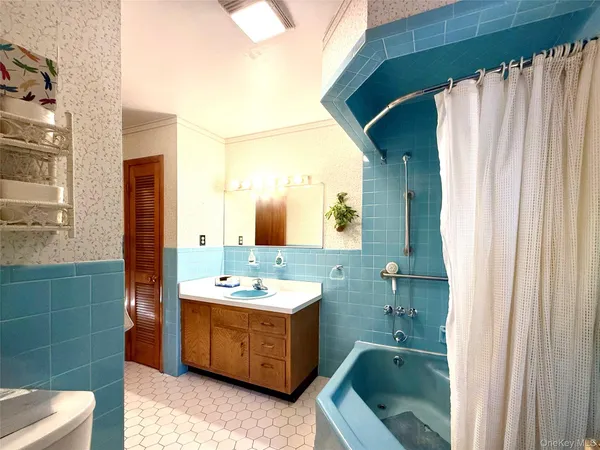 a bathroom with a sink mirror and a bathtub