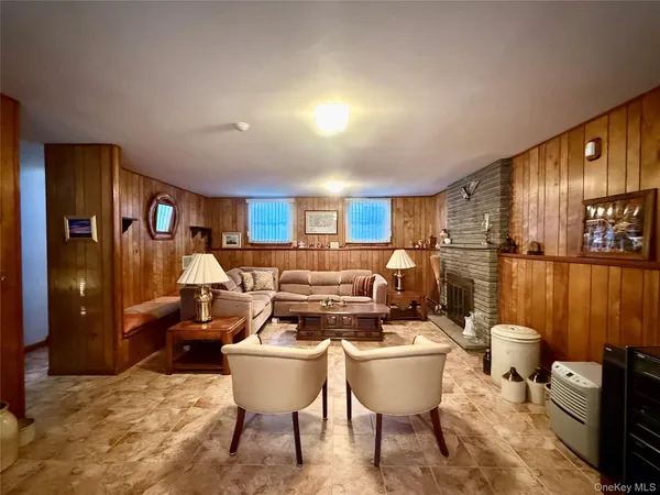 a living room with furniture a lamp and a dining table