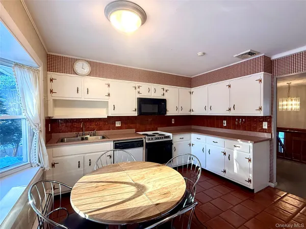 a kitchen with a sink stove and cabinets