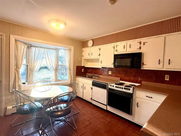 a kitchen with a stove a sink and a microwave