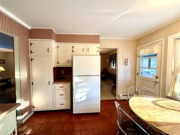a kitchen with refrigerator and window