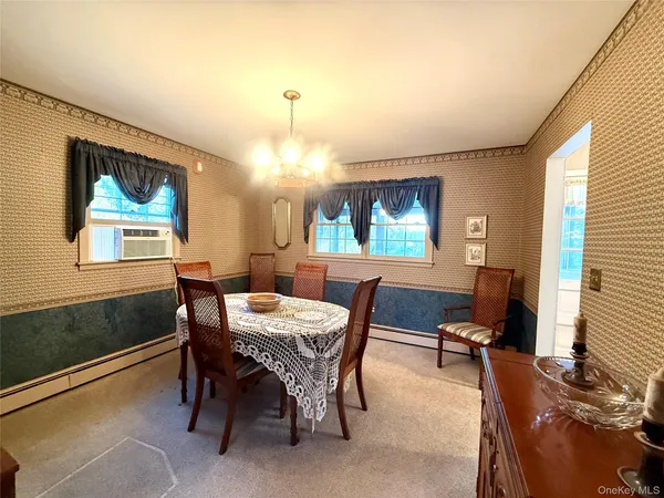 a view of a dining room with furniture and window