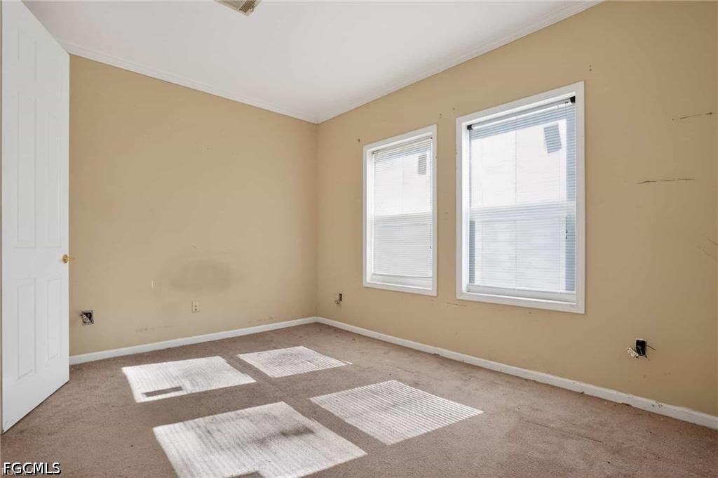 2808 34th Street Southwest Lehigh Acres, FL 33976 - Photo 14 of 14 a view of an empty room with a window