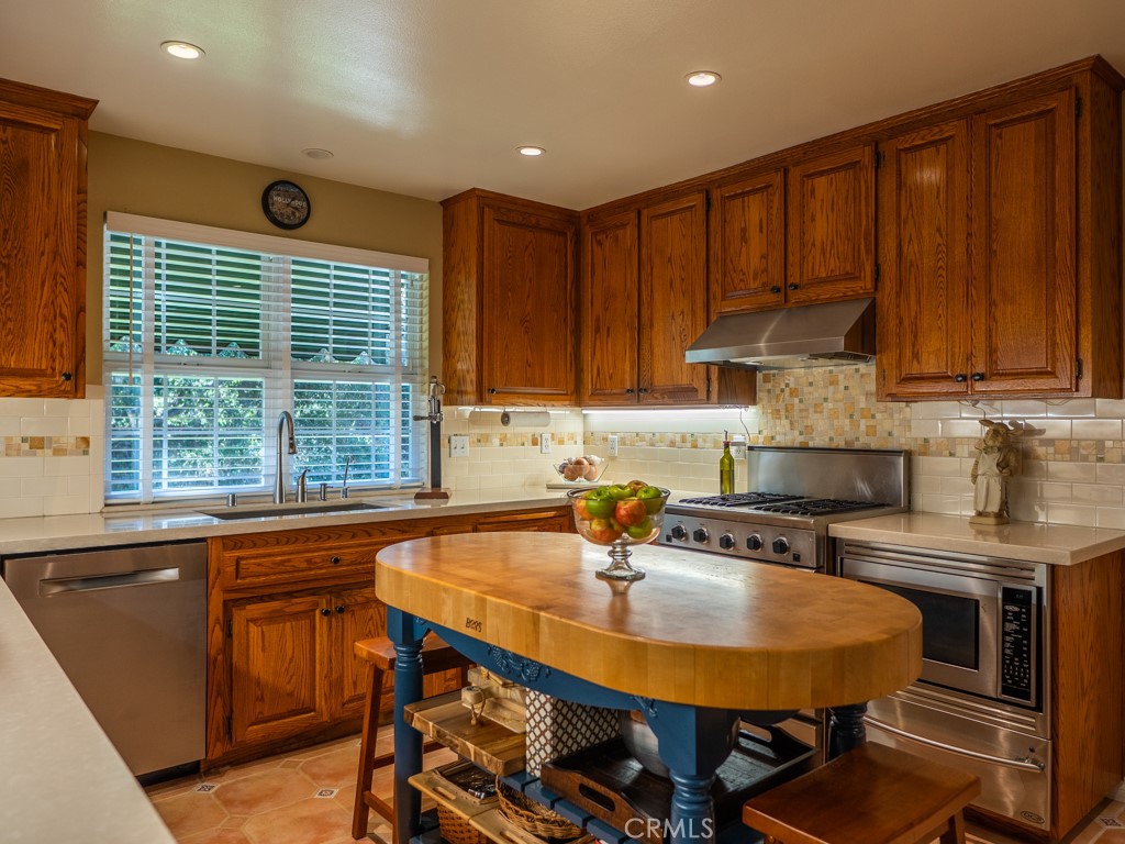 1934 Pasadena Glen Road Pasadena, CA 91107 - Photo 11 of 38 a kitchen with a table chairs sink and cabinets