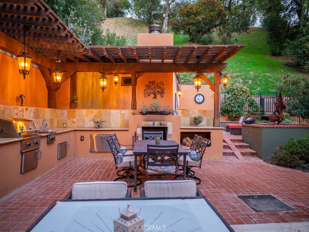 1934 Pasadena Glen Road Pasadena, CA 91107 - Photo 33 of 38 a view of a patio with dining table and chairs with a barbeque grill and couches