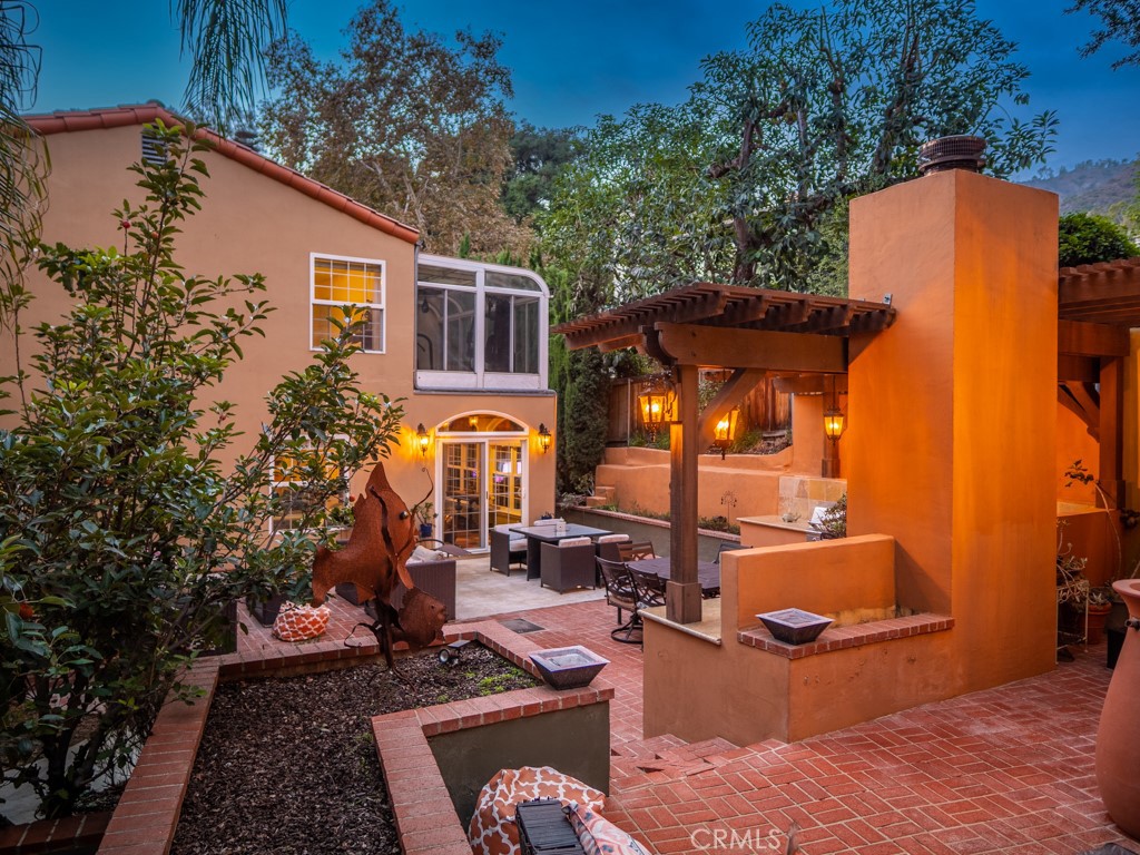 1934 Pasadena Glen Road Pasadena, CA 91107 - Photo 35 of 38 a view of a patio with couches table and chairs and potted plants