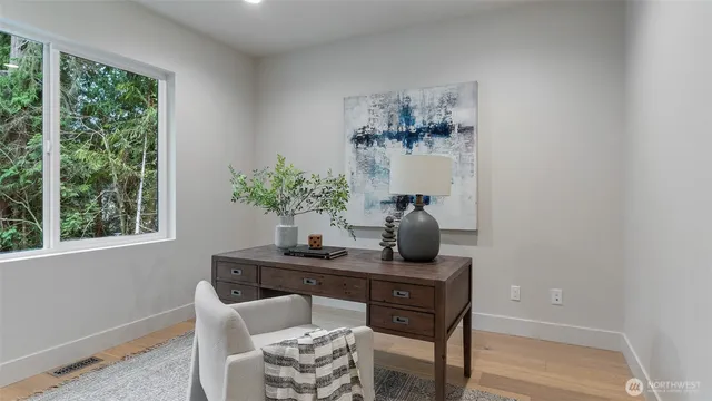 a dining room with furniture window and wooden floor