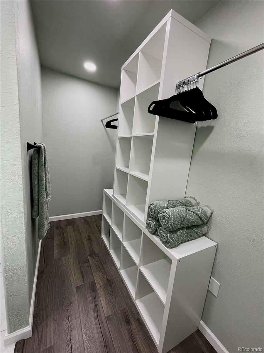 265 Caesar Road Black Hawk, CO 80422 - Photo 32 of 42 a room with a walk in closet and wooden floor