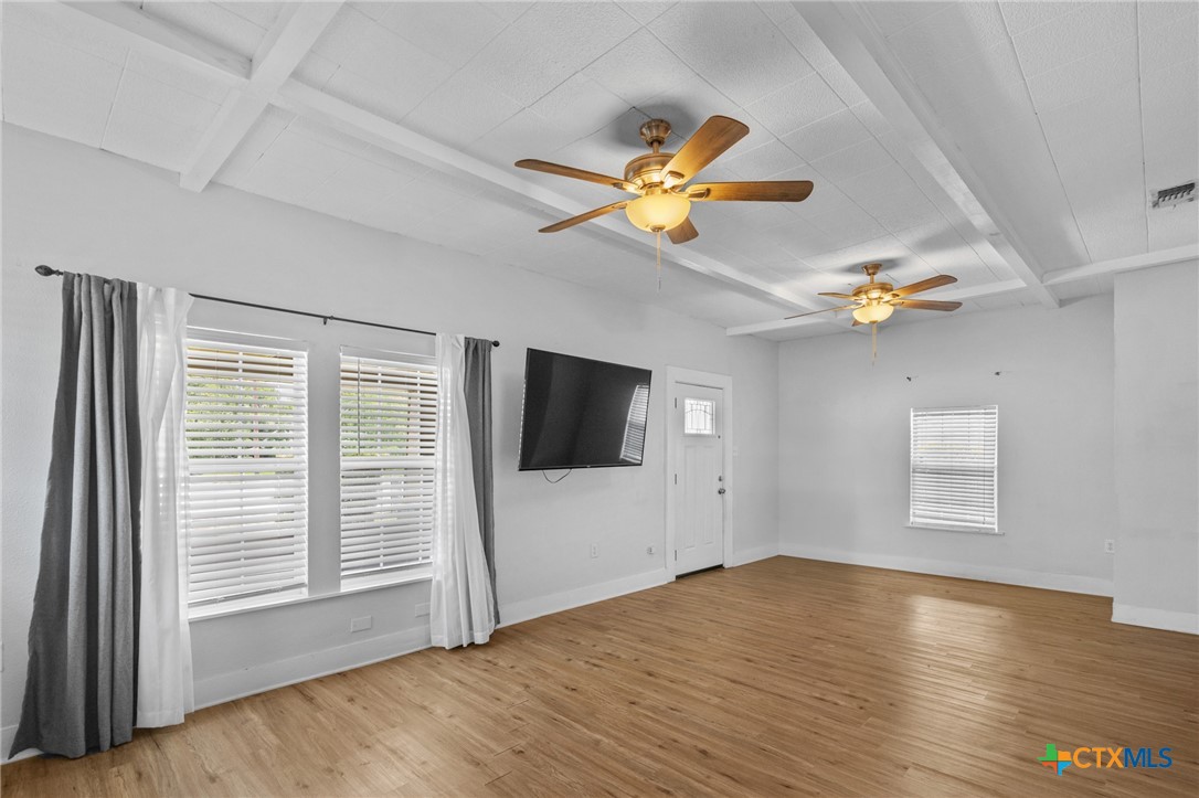 905 North Navarro Street Victoria, TX 77901 - Photo 13 of 28 a view of an empty room with a window and wooden floor