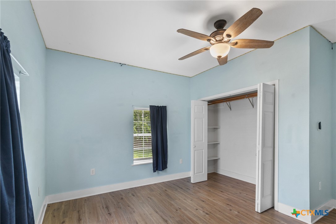 905 North Navarro Street Victoria, TX 77901 - Photo 15 of 28 a view of an empty room with window and wooden floor