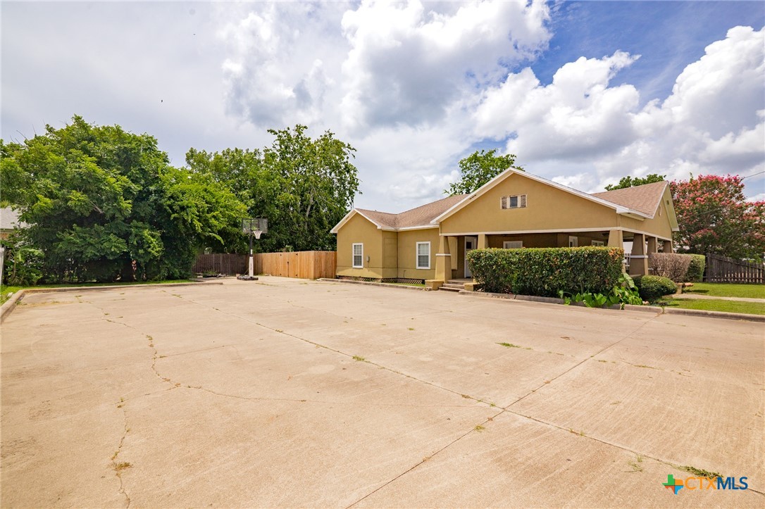 905 North Navarro Street Victoria, TX 77901 - Photo 4 of 28 a front view of a house with a yard and garage