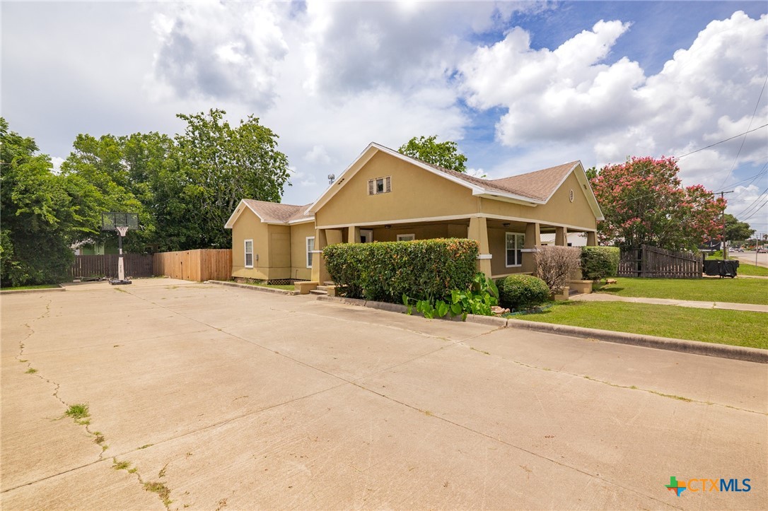 905 North Navarro Street Victoria, TX 77901 - Photo 5 of 28 a front view of a house with a yard and garage