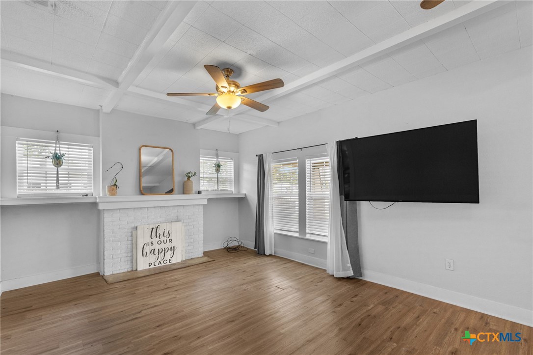 905 North Navarro Street Victoria, TX 77901 - Photo 8 of 28 a living room with a flat screen tv and a kitchen view