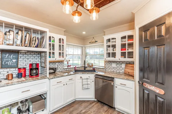 a kitchen with stainless steel appliances granite countertop a stove and cabinets