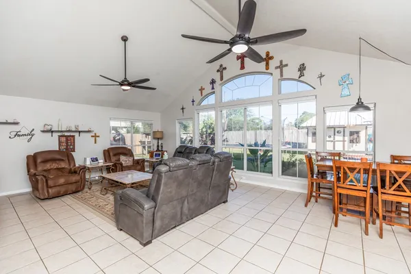 a living room with furniture and a view of dining room