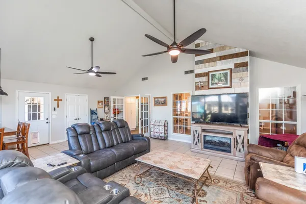 a living room with furniture a flat screen tv and a fireplace