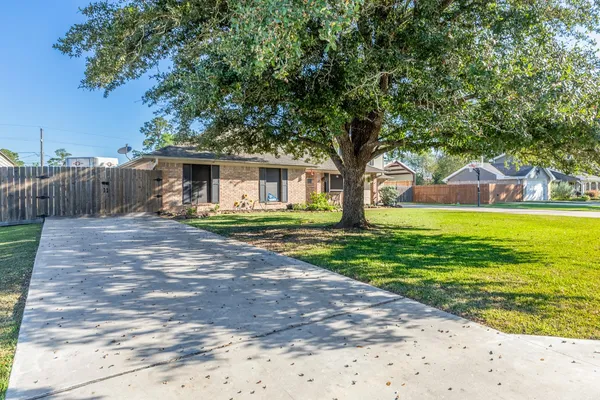 a front view of a house with yard and green space