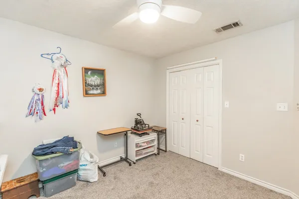 a living room with furniture and a baby crib