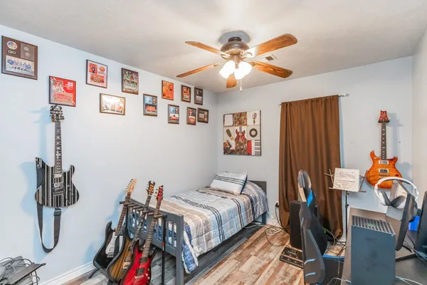 a bedroom with a bed and a chandelier