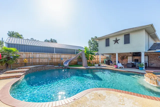 a view of a house with a backyard porch and sitting area