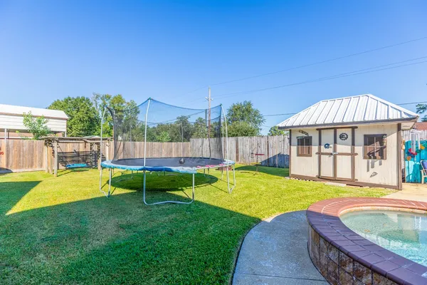 a view of a house with backyard and sitting area