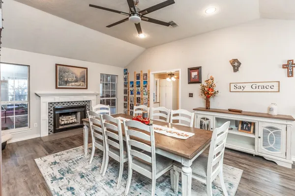 a dining room with furniture a rug and wooden floor