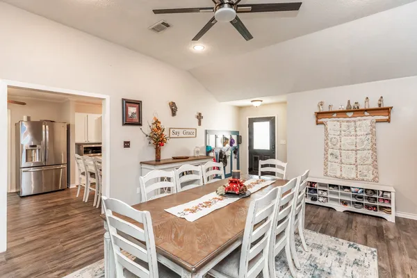 a view of a dining room with furniture and wooden floor