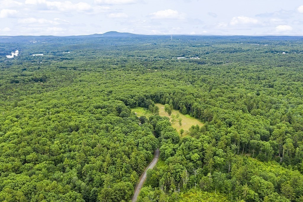 73 Old County Road Ashburnham, MA 01430 - Photo 3 of 38 a view of a lush green outdoor space with a mountain