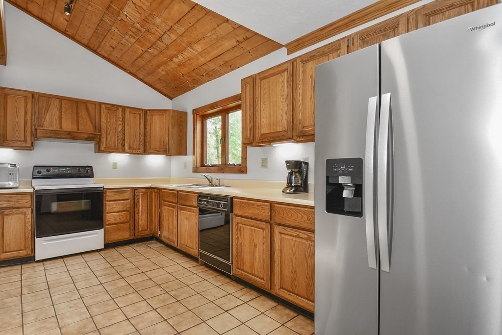 73 Old County Road Ashburnham, MA 01430 - Photo 6 of 38 a kitchen with stainless steel appliances granite countertop a refrigerator and a stove top oven
