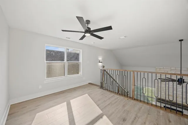 a view of a livingroom with a ceiling fan and window