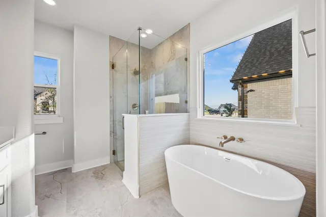 a bathroom with a white tub a mirror and vanity