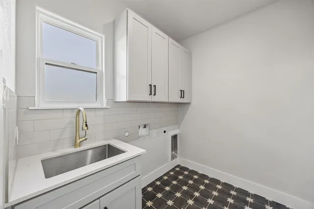 a kitchen with a sink and cabinets