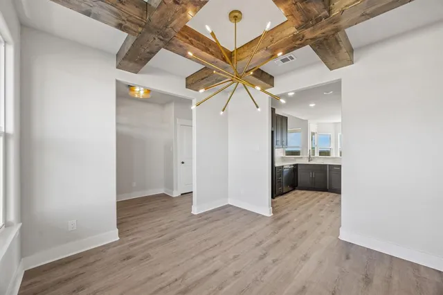 a view of a kitchen with a sink and a refrigerator