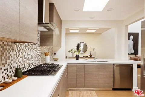 a kitchen with a sink a stove and cabinets