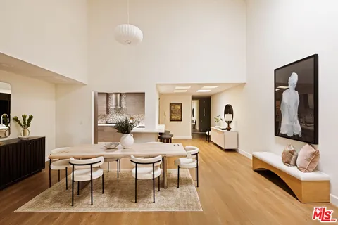 a living room with furniture a rug and a large mirror