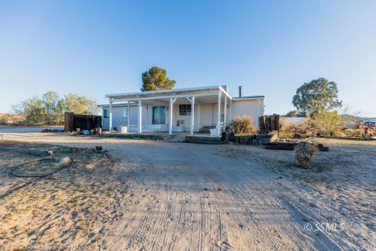 1221 Nocturne Street Ridgecrest, CA 93555 - Photo 3 of 32 a front view of a house with a yard