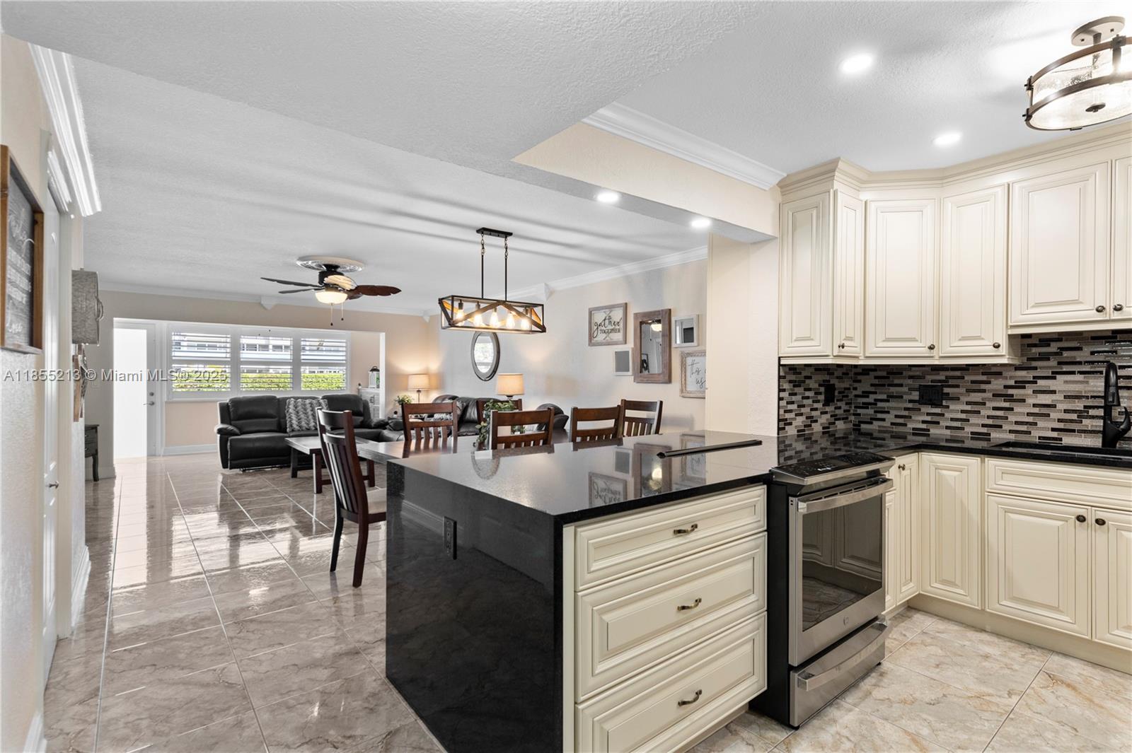 329 Southeast 3rd Street, Unit 105T Hallandale Beach, FL 33009 - Photo 1 of 25 a kitchen with counter top space appliances and cabinets